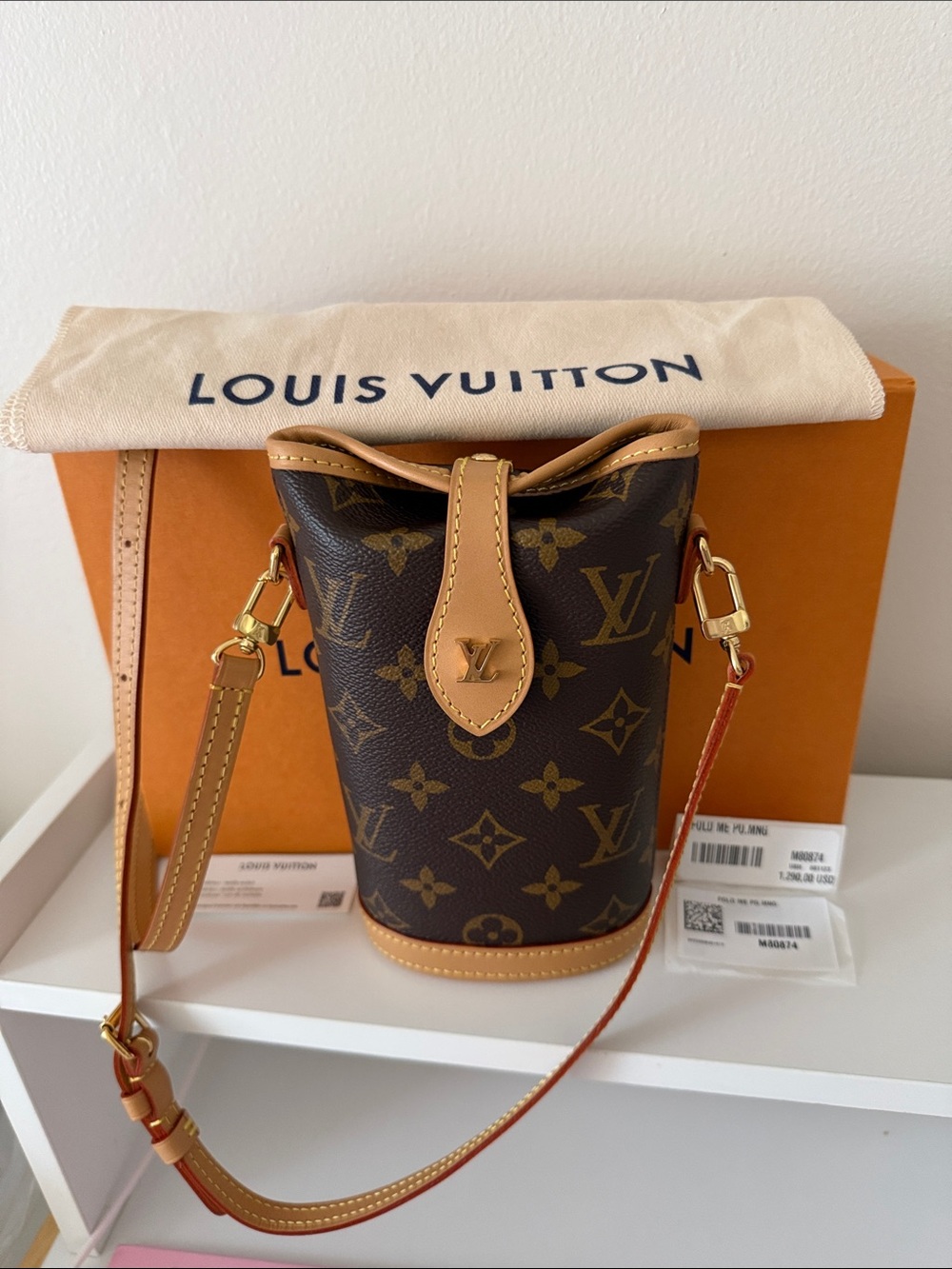 Louis Vuitton Monogram Canvas FOLD ME crossbody mini bag with Vachetta Trim.